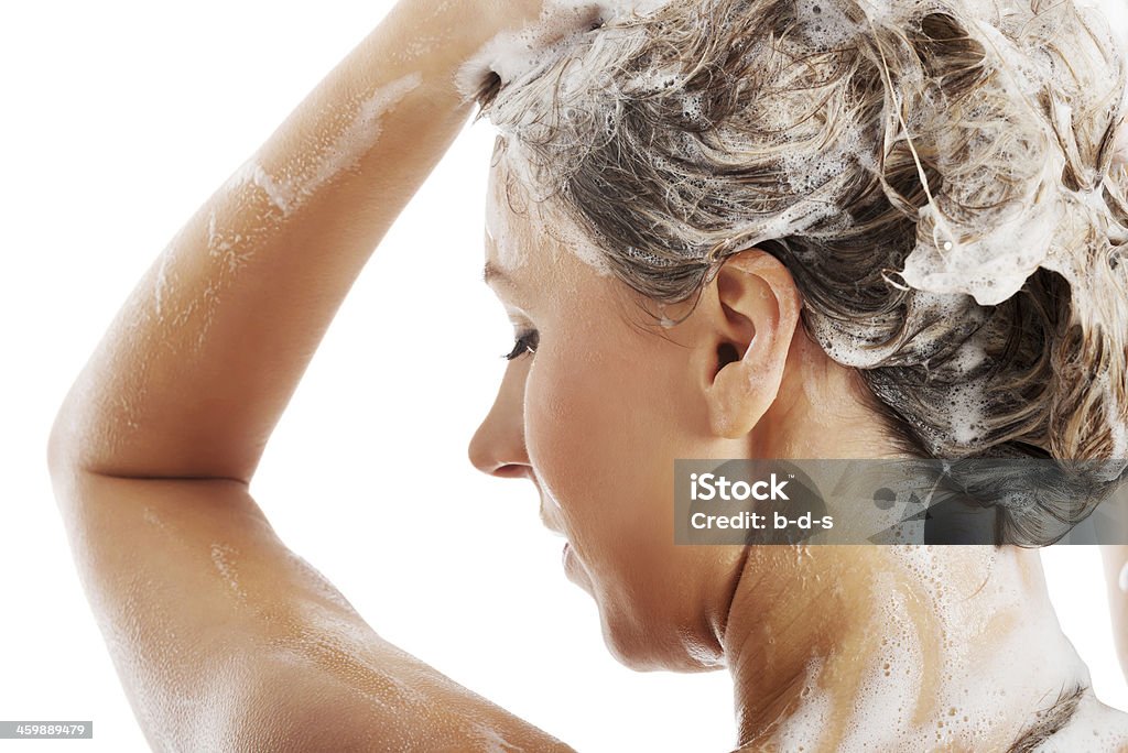 Beautiful woman taking a shower and shampooing her hair. Beautiful woman taking a shower and shampooing her hair. Isolated on white. Adult Stock Photo