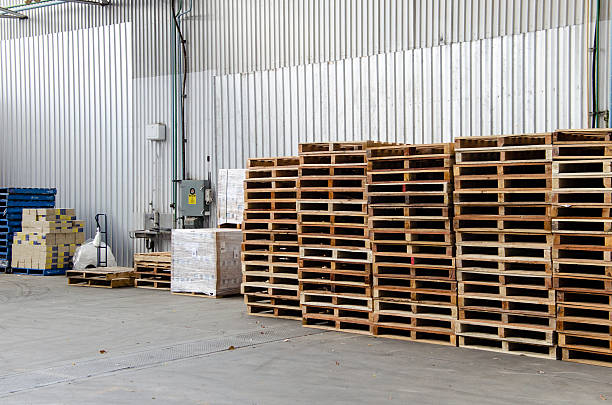 istock Wooden pallets stacked inside a warehouse 459891373