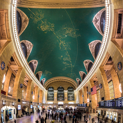 New York, USA - December 25, 2012: Main Concourse of the Grand Central Terminal railroad station in New York City. The Grand Central Terminal is an iconic landmark, famous for it's spherical ceiling depicting the astronomical sky with stars and constellations.