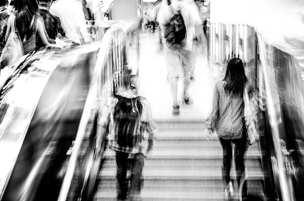 istock business people on escalator abstract blur 459894807