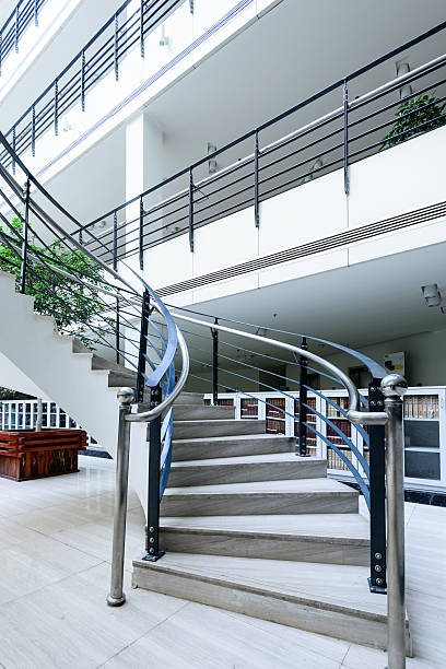 istock Sleek metal spiral staircase, modern architectural interior decoration. 459900563