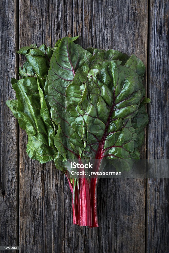 Raw Organic Red Ruby Swiss Chard Organic red ruby swiss chard raw on rustic wood Bright Stock Photo