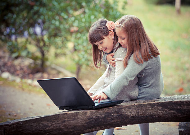 istock girlfriend in autumn park with laptop 459904305