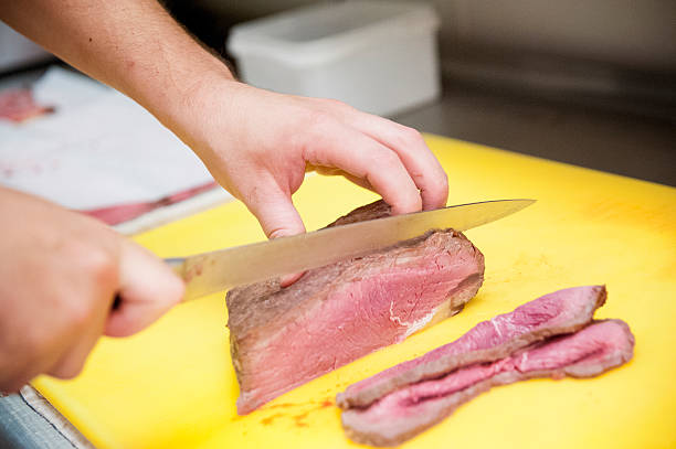 istock Meat being prepared and cut in a restaurant kitchen 459907933