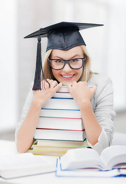 istock student woman in bachelor cap with books 459907935