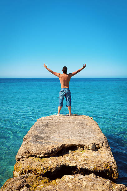 istock Man with Arms Wide Open on Blue Tropical Sea 459910663