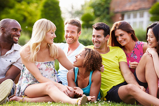 istock Group Of Friends Sitting On Grass Together 459911245