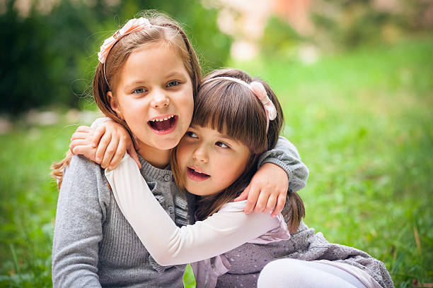 istock Happy little girlfriends in park 459911647