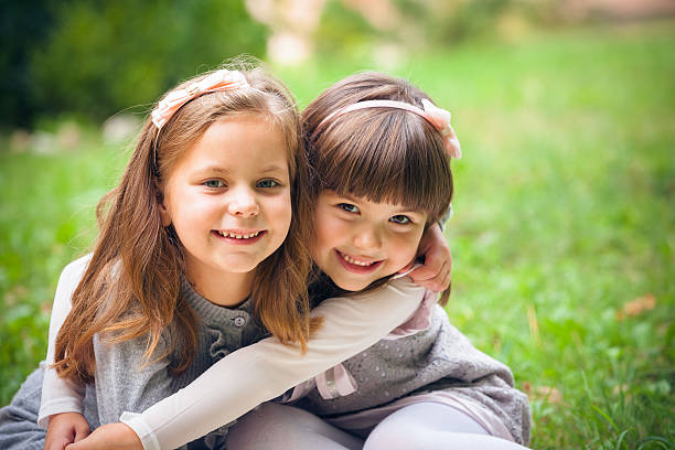 istock Happy little girlfriends in park 459911649