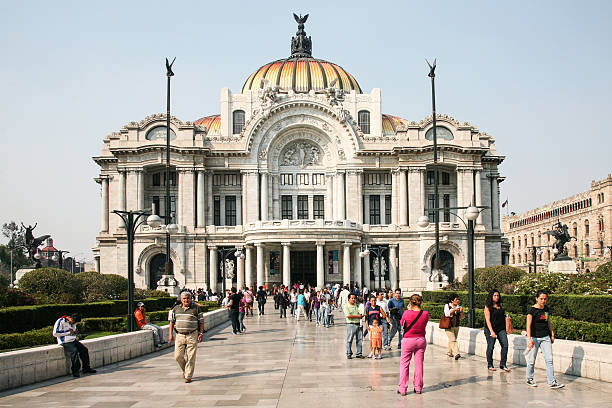 Quito, Pichincha, Ecuador: the Numismatic Museum of the Central Bank of Ecuador, located at the intersection of Calle Antonio José Sucre and Calle Gabriel García Moreno in the Historic Center of Quito. Designed by architect Francisco Durini Cáceres and completed in the early 20th century, the building originally served as the headquarters for the Central Bank of Ecuador. The monumental stone facade features neoclassical architectural elements, including large fluted columns and a rounded attic story adorned with allegorical statues holding torches. The structure is a significant landmark within the UNESCO World Heritage site, situated near the Church of the Society of Jesus.