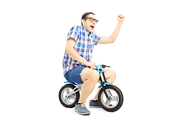 istock Excited young male riding a bicycle and gesturing 459912479