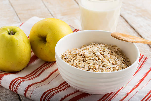 istock Oat flakes in bowl with apple and milk 459912769