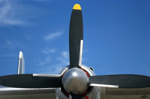 Small plane propeller closeup against blue sky