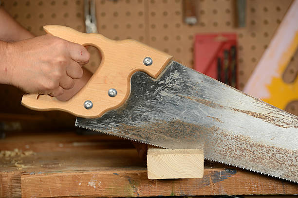 istock Carpenter Sawing Wood 459915779