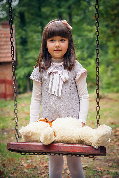 istock Small beautiful girl and amusing bear 459916477