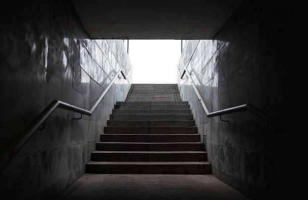 istock Underground passage with stairs in the glowing end 459918719