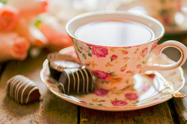 istock Cup of tea with roses and chocolate candies 459923327