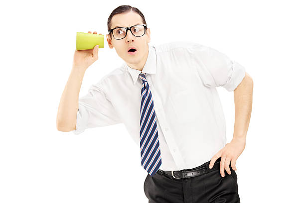 istock Young man listening through the wall with a cup 459924015