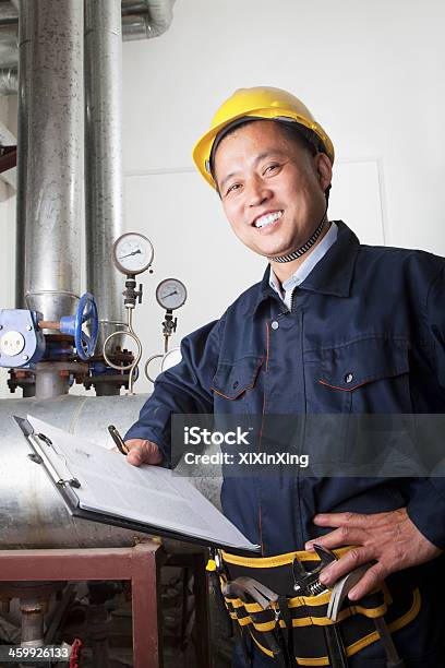 Worker Checking The Oil Pipeline Equipment Stock Photo - Download Image Now - 50-54 Years, China - East Asia, Chinese Ethnicity