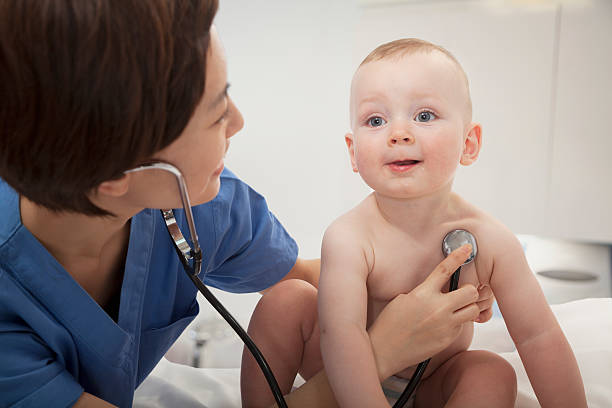 istock Smiling doctor checking a baby's heartbeat with stethoscope 459926517