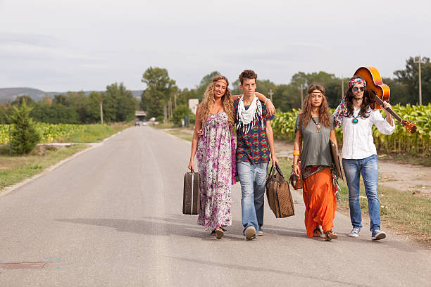 istock Hippie Group Walking on a Countryside Road 459927663