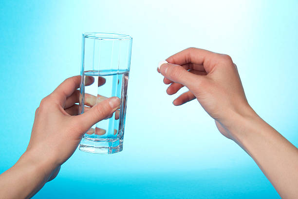 istock The hands holding tablet and glass with water 459928317