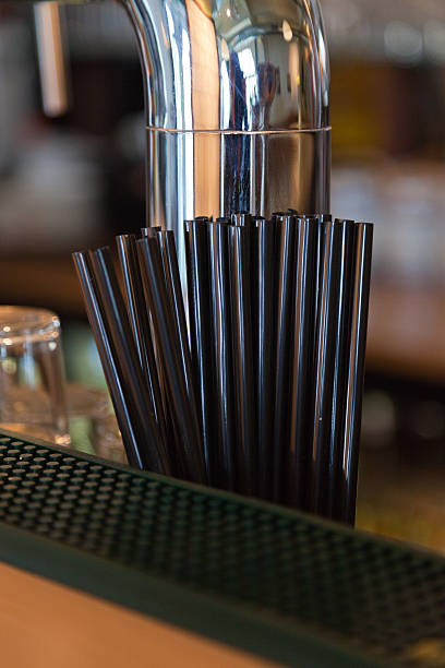 istock Black straws on bar near beer tap. 459928809