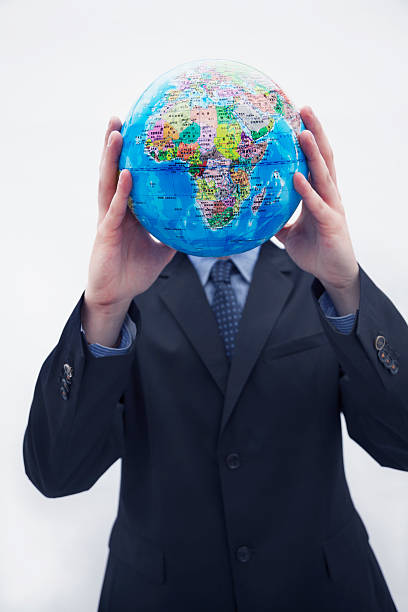 istock Businessman in suit holding up a globe 459928987