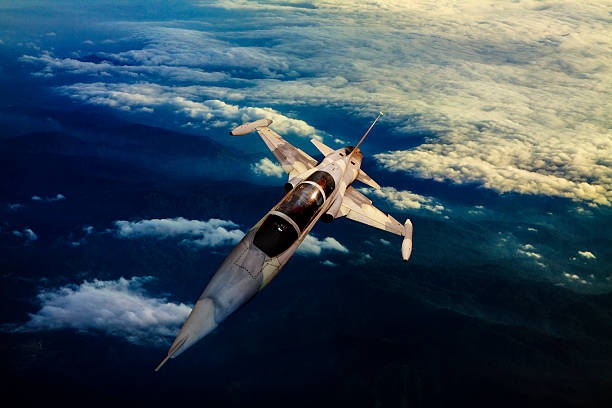 istock military jet plane flying over mountain country view below 459937735