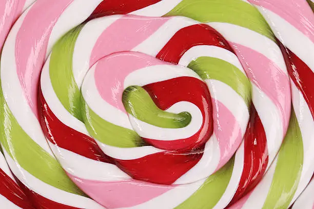 Colorful spiral lollipop. Close up. Whole background.