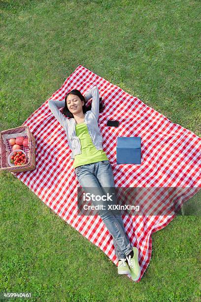 Smiling Young Woman Lying On Her Back Stock Photo - Download Image Now - Picnic, One Woman Only, Lying Down