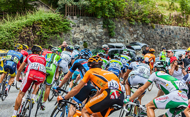 The Peloton on Alpe D'Huez Alpe-D'Huez,France- July 18, 2013: The peloton climbing the difficult road to Alpe-D'Huez, during the stage 18 of the edition 100 of Le Tour de France 2013. group of people people recreational pursuit climbing stock pictures, royalty-free photos & images
