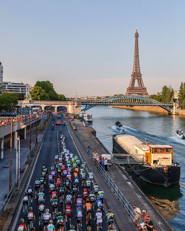 Paris, France- July 21st, 2013: The peloton riding on the Seine riverside near the Eiffel Tower during the last stage of the 100th edition of Le Tour de France 2013, in Paris