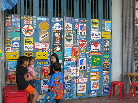 Bangkok, Thailand – December 22, 2013 –  A view near China Town in Bangkok, Thailand. A group of Children on the sidewalk near China Town.