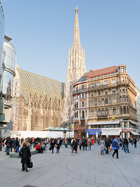 side view of Stephansdom in Vienna Vienna, Austria - March 9, 2011:  tourists near Stephansdom on Stephansplatz in Vienna, Austria on March 9, 2011. Stephansplatz is a square at the geographical centre of old Vienna people shopping in graben street vienna austria stock pictures, royalty-free photos & images