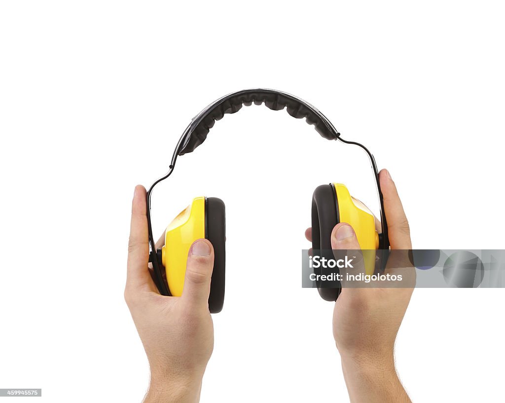 Hands holds working protective headphones. Hands holds working protective headphones. Isolated on a white background. Acoustic Guitar Stock Photo