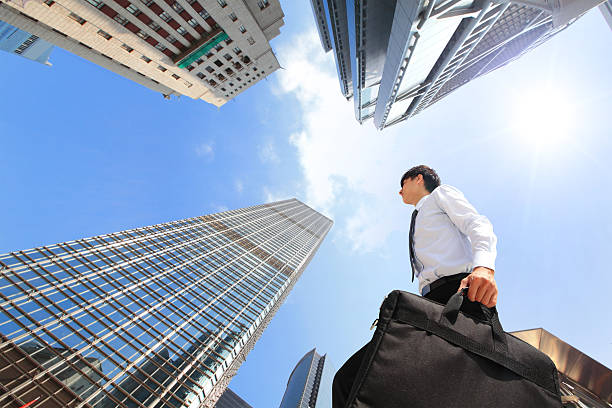 istock Business man with briefcase walking outside near buildings 459949309
