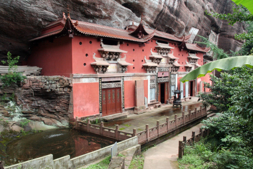 Temple building leaning against a vertical rock in Qiyun Taoist complex, Anhui province, China