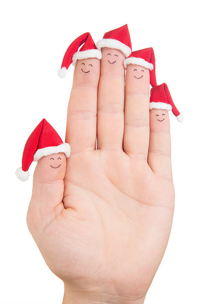 istock Fingers Christmas faces in Santa hats. 459954281