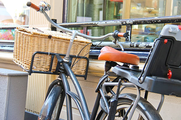 istock Bicycle with wicker basket stands near wall 459954363