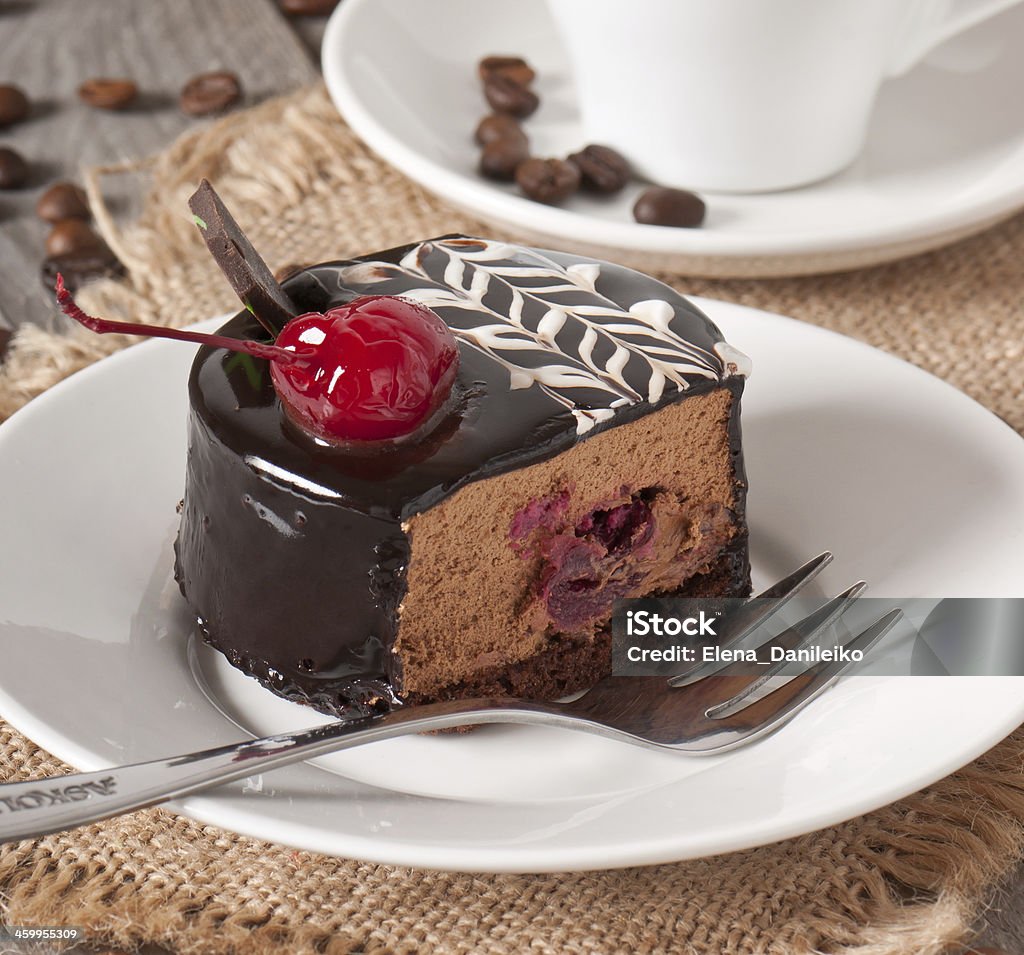 Sweet dessert fruitcake with a cherry Sweet dessert fruitcake with a cherry and a cup of coffee Brown Stock Photo