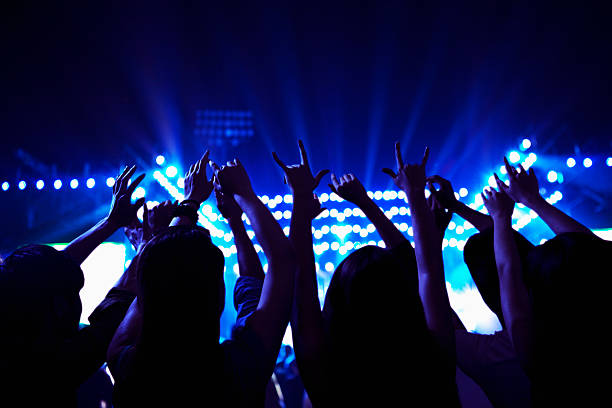 istock Audience watching a rock show, hands in the air, 459958151