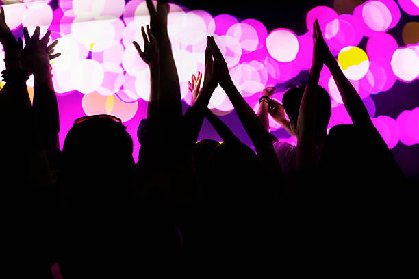 istock Audience watching a rock show, hands in the air 459958157