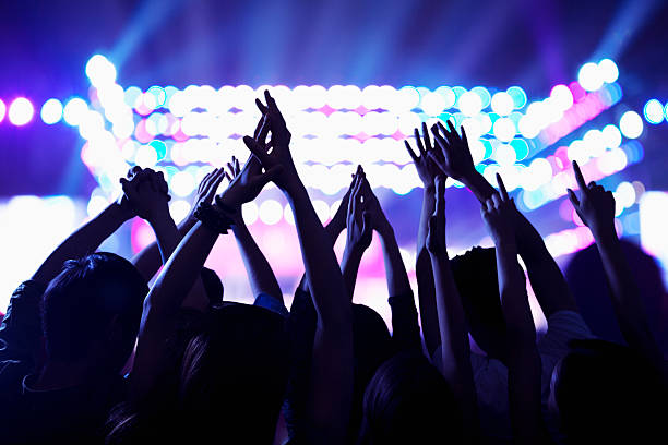istock Audience watching a rock show, hands in the air 459958161