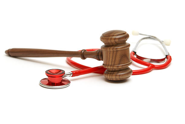 Wooden gavel and stethoscope representing medical lawsuit stock photo