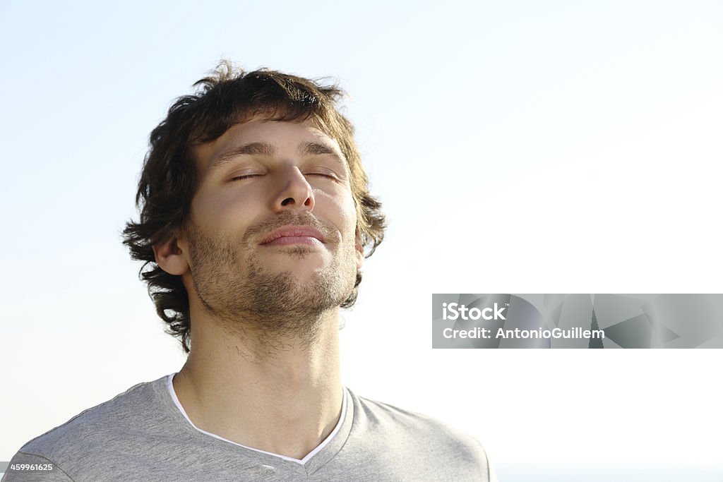 Attractive man breathing outdoor Attractive man breathing outdoor with the sky in the background Men Stock Photo