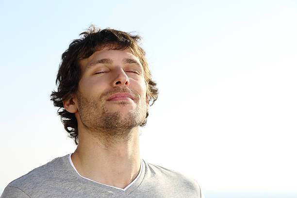 homem atraente respiração ao ar livre - inhaling breathing exercise one person relaxation - fotografias e filmes do acervo