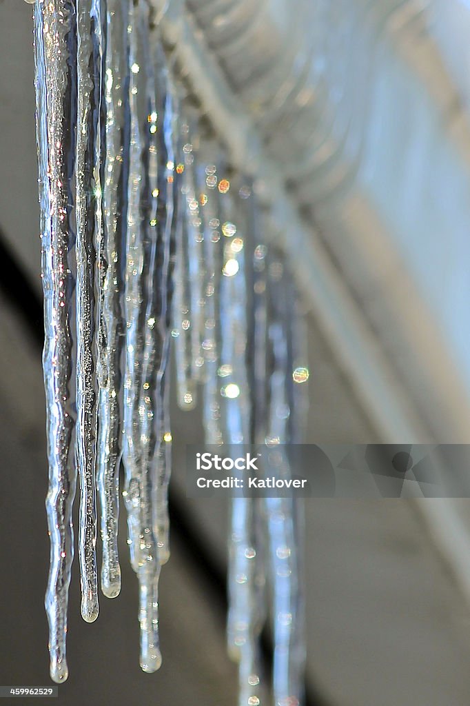 Rainbow, sparkled, Icicles Icicles hang from a gutter reflecting the sunlight making rainbows and sparkles Roof Gutter Stock Photo