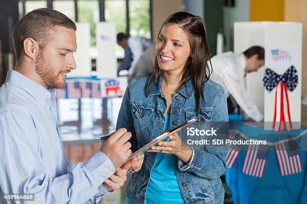 Woman Taking Exit Poll Interview On Election Day Stock Photo - Download Image Now - Voting, Questionnaire, Voter Registration
