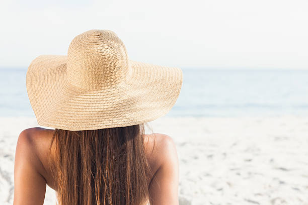 istock Woman with sunhat looking at ocean 459965705
